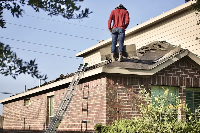 Professional roofer working on a residential roof in La Marque